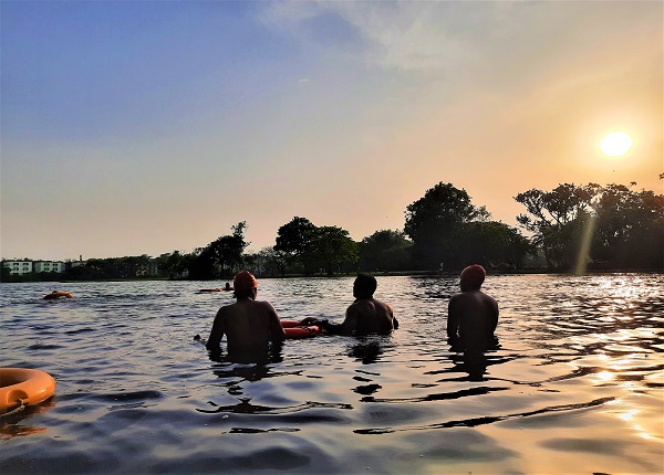 People standing in a water body with protective equipments