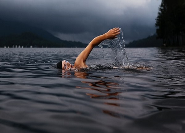 Man swimming on body of water